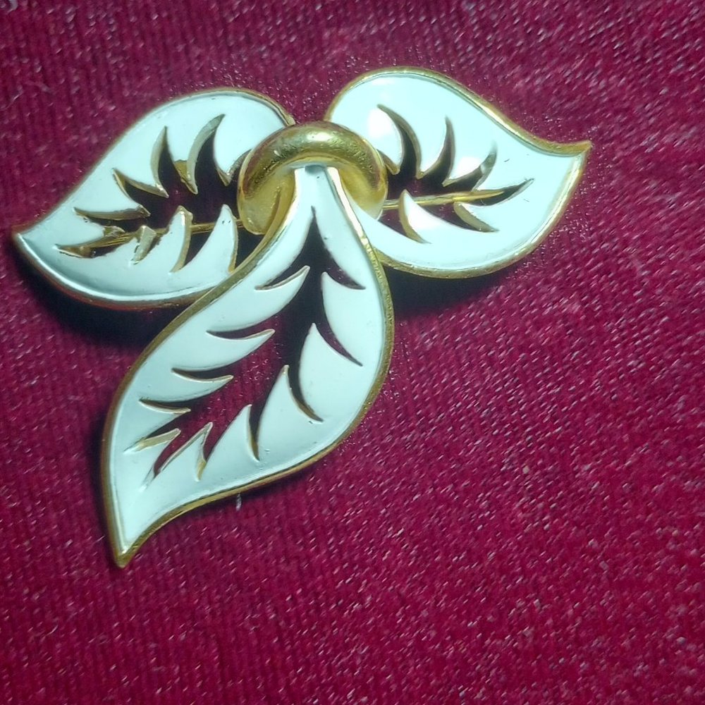 Triple leaf white enamel and gold tone brooch